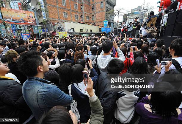 Young Taiwanese gather for a street concert by a local pop singer, after weeks of political campaign rallies that dominated the daily life in Taipei...