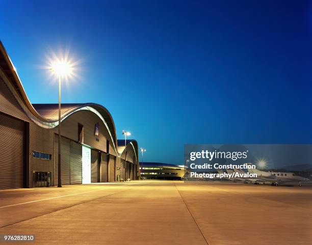 The tower of Farnborough airport and Hangars with parked airoplane. Designed by 3d reid architects.