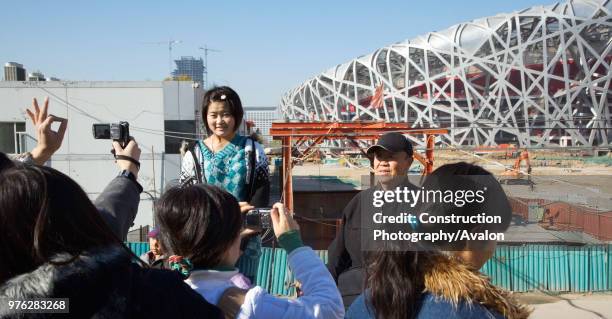 Tourists taking photos of Beijing National Stadium, also known as the Bird's Nest, Beijing, China.