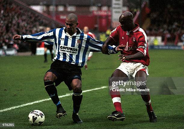 Junior McDougald of Dagenham holds off Richard Rufus of Charlton during the AXA FA Cup third round match between Charlton Athletic and Dagenham and...