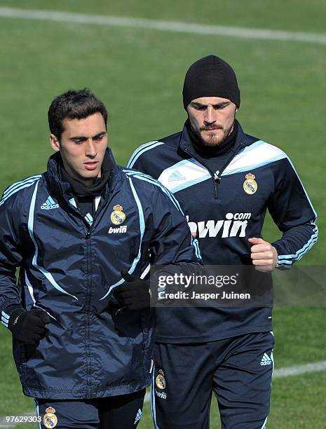 Goalkeeper Iker Casillas of Real Madrid runs with a teammate during a training session, the day after Real Madrid's UEFA Champions League aggregate...