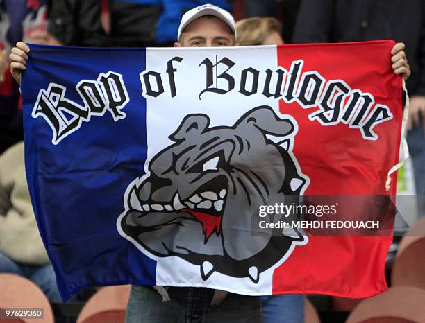 Supporter of the Paris Saint-German football team holds a banner reading "Kop of Boulogne" at the so-called Boulogne stand of the Parc-des-Prince...