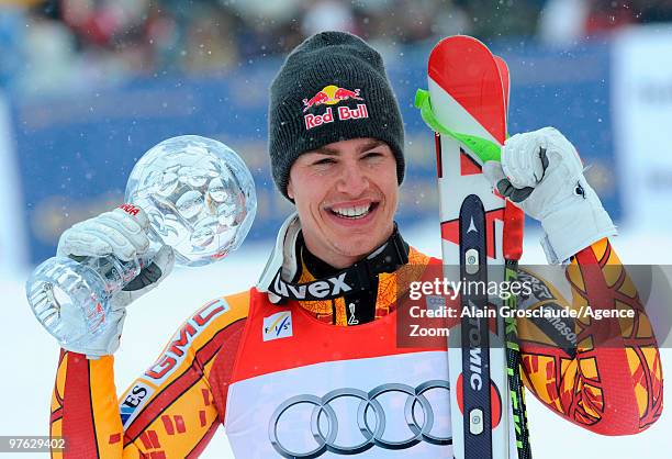 Erik Guay of Canada takes the globe for the overall World Cup Super G during the Audi FIS Alpine Ski World Cup Men's Super G on March 11, 2010 in...