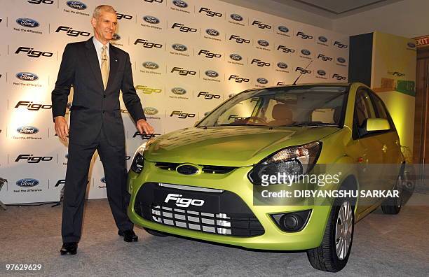 Executive Director of Ford India, Nigel Wark poses next to the newly launched Ford Figo during a press conference in Bangalore on March 10 2010. Auto...