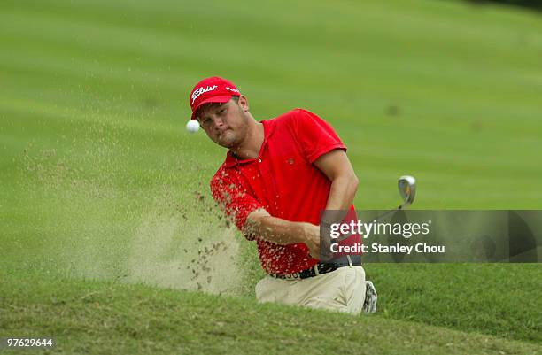 Guido Van Der Valk of the Netherlands hits out of the bunker on the 17th during Asian International Final Qualifying for The Open at Saujana Golf and...