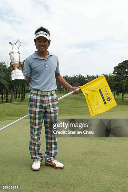 Hiroyuki Fujita of Japan celebrates with the Claret Jug on the 18th green during Asian International Final Qualifying for The Open at Saujana Golf...