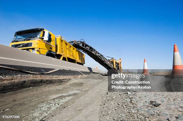 Plaining machine removing old tarmac surface.