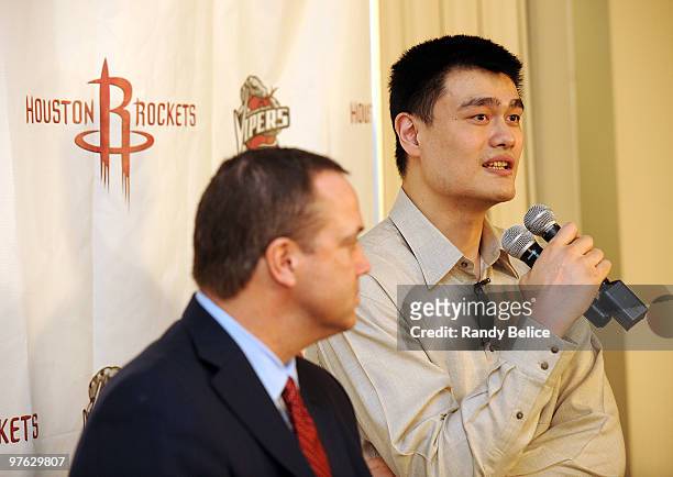 Yao Ming of the Houston Rockets responds to a question from the media while Tad Brown, Rockets CEO listens during a press conference prior to the NBA...