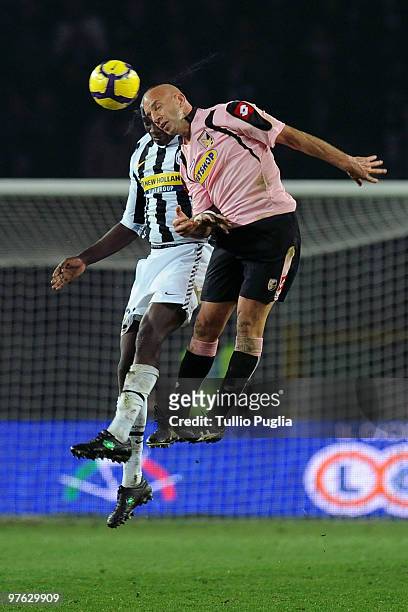 Mohamed Sissoko of Juventus and Giulio Migliaccio of Palermo compete for a header during the Serie A match between Juventus and Palermo at Stadio...