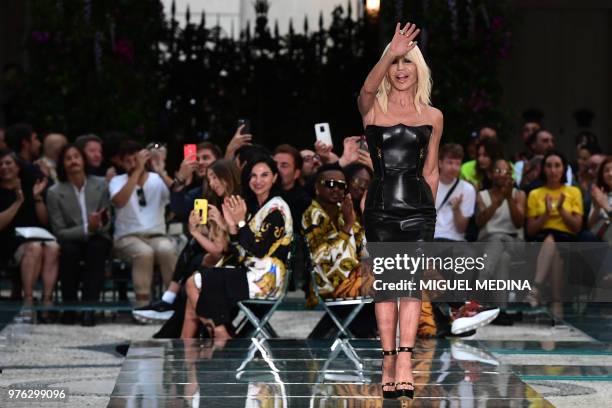 Italian designer Donatella Versace acknowledges the audience at the end of the Versace men & women's spring/summer 2019 collection fashion show in...