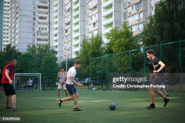 Teenagers play football in a 'korobka' next to their high rise tenement homes in the Moscow suburb of Timiryazevskaya on June 16, 2018 in Moscow,...