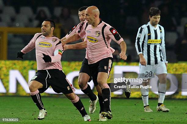Fabrizio Miccoli of Palermo celebrates his goal with team mates Cesare Bovo and Giulio Migliaccio as Diego Da Cunha of Juventus shows his dejection...