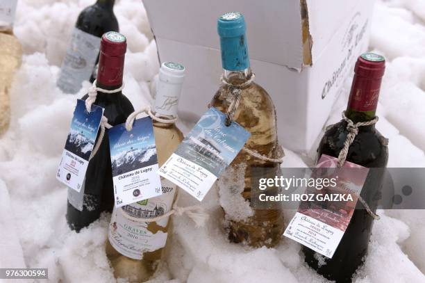 Bottles of wine from the Chateau de Lugey by Bordeaux winemaker Franck Labeyrie are placed in snow at the ski station in Cauterets, Pyrenees,...