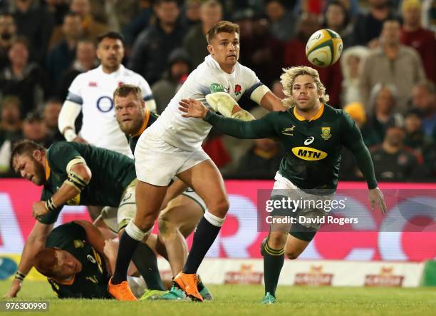 Faf de Klerk of South Africa passes the ball as Henry Slade challenges during the second test match between South Africa and England at Toyota...