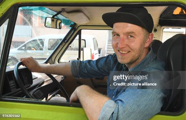 May 2018, Germany, Bremen: Thomas Pieczka sitting behind the wheel of his T3, which he calls "Shrek". Pieczka rents out "Shrek" and two other vans....