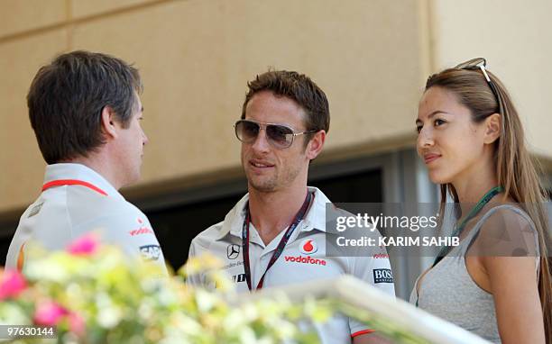 McLaren Mercedes' British driver Jenson Button and his girlfriend Jessica Michibata are pictured in the paddock of the Bahrain international circuit...