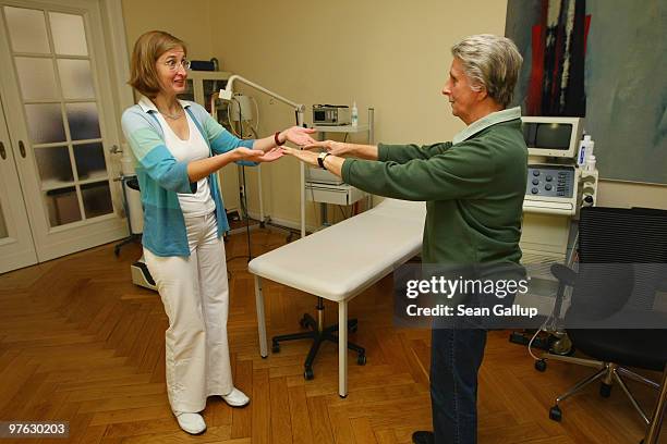 Family doctor checks an elderly patient's balance and coordination at her office on October 13, 2009 in Berlin, Germany. German political parties...