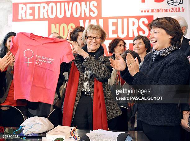 French Socialist Party leader Martine Aubry receives a tee-shirt from Montpellier Mayor and socialist candidate for the upcoming regional elections...