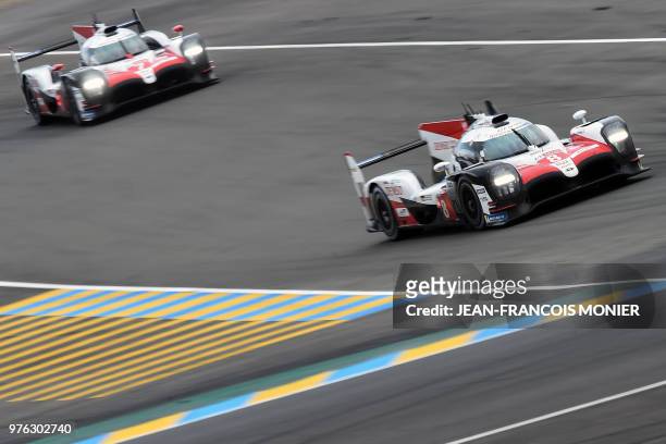Toyota TS050 Hybrid LMP1 Spain's driver Fernando Alonso competes ahead of the Toyota TS050 Hybrid LMP1 driven by Argentine's Jose Maria Lopez during...