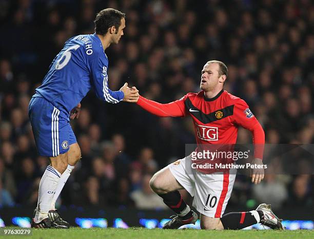 Wayne Rooney of Manchester United is helped to his feet by Ricardo Carvalho of Chelsea during the FA Barclays Premier League match between Chelsea...