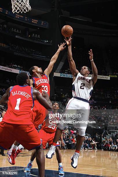 Joe Johnson of the Atlanta Hawks shoots against Willie Green of the Philadelphia 76ers on March 3, 2010 at Philips Arena in Atlanta, Georgia. NOTE TO...
