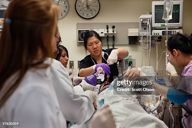 Staff in the Trauma Unit at the John H. Stroger Jr. Cook County Hospital try to save the life of a man who was hit by a car November 6, 2009 in...