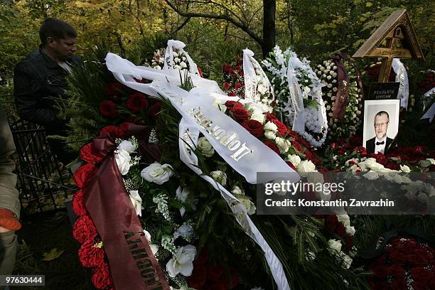 Mourner stands near the grave of Russian mafia godfather Vyacheslav Ivankov, known as Yaponchik or Little Japanese, at Vagankovskoye cemetery October...