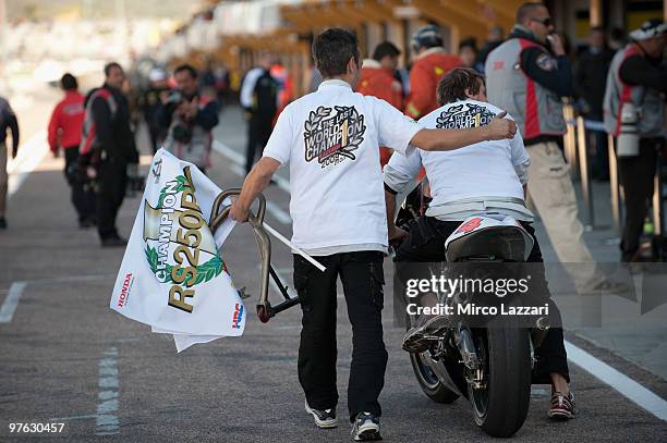 The mechanics of Hiroshi Aoyama of Japan and Scot Racing 250cc celebrates with T-shirt and flag the victory in 250 cc world champion after the MotoGP...