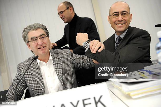 Nick Hayek Jr, chief executive officer of Swatch Group AG, left, gestures with Thierry Kenel, chief financial officer of Swatch Group AG, during the...