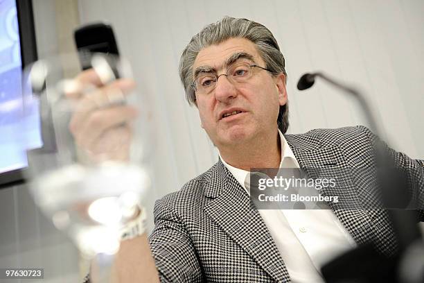 Nick Hayek Jr, chief executive officer of Swatch Group AG, checks his mobile phone during the company's annual results news conference in Biel,...