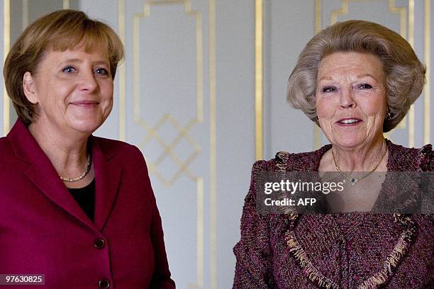 German Chancellor Angela Merkel is welcomed by Dutch Queen Beatrix in the Hague on March 11, 2010 during her one-day state visit to the Netherlands....