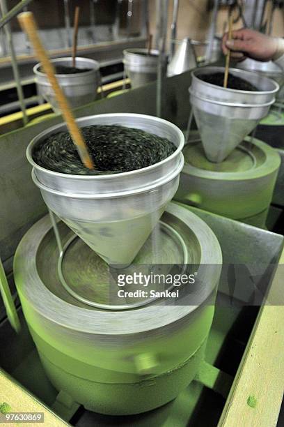 Tea leaves are grounded with millstone in the Japanese tea factory "Tsujirihei Honten" on February 18, 2010 in Uji, Kyoto, Japan. Tsujirihei, long...