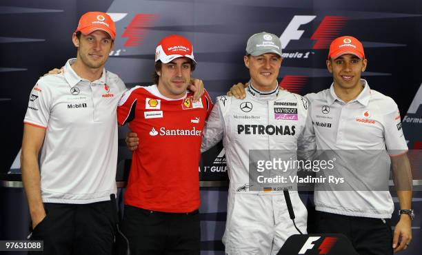 Current F1 World Champion Jenson Button of Great Britain and McLaren Mercedes appears with former champions Fernando Alonso of Spain and Ferrari,...