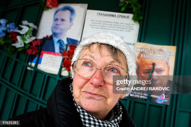 Serbian woman stands by the entrance near to the grave of late Yugoslav President Slobodan Milosevic in the town of Pozarevac on March 11, 2010....