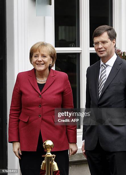 German Chancellor Angela Merkel meets Dutch Prime Minister Jan Peter Balkenenende on her arrival in the Hague on March 11, 2010. Merkel is on a one...
