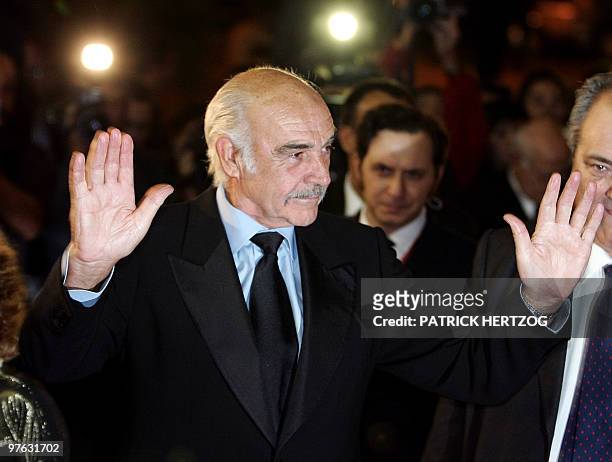 Scottish actor Sean Connery waves to photographers as he arrives for the opening concert of the first edition of the Rome Film Festival, at the...