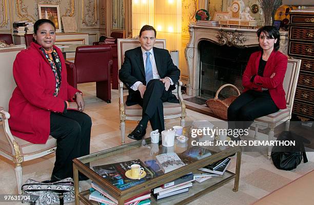 French Immigration Minister Eric Besson poses at his ministry in Paris on March 8 with Sudan's journalist Lubna Ahmed al-Hussein and Sihem Habchi ,...