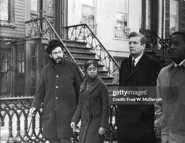 American politician and Mayor of New York John V. Lindsay walks with journalist and music critic Nat Hentoff and several unidentified others during...