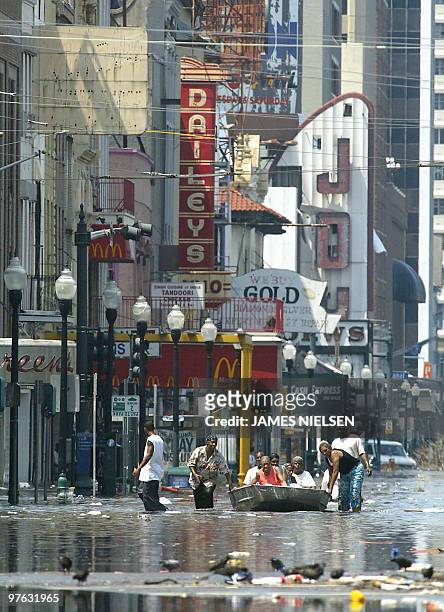 Residents attempt to escape flood waters 31 August 2005 in New Orleans, Louisiana, in aftermath of Hurricane Katrina. With most of New Orleans...