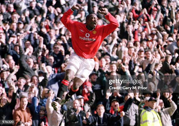 Dwight Yorke of Man Utd celebrates after scoring the second goal during the Manchester United v Arsenal FA Carling Premiership match at Old Trafford,...