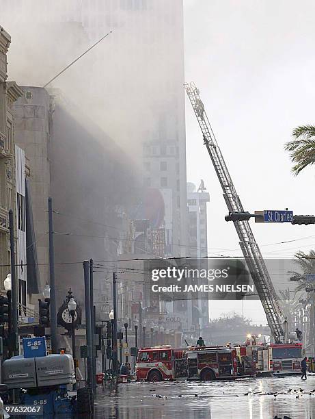 New Orleans Fire Department firefighters work a blaze despite the high flood waters 31 August 2005 at an athletic footware store that was looted in...