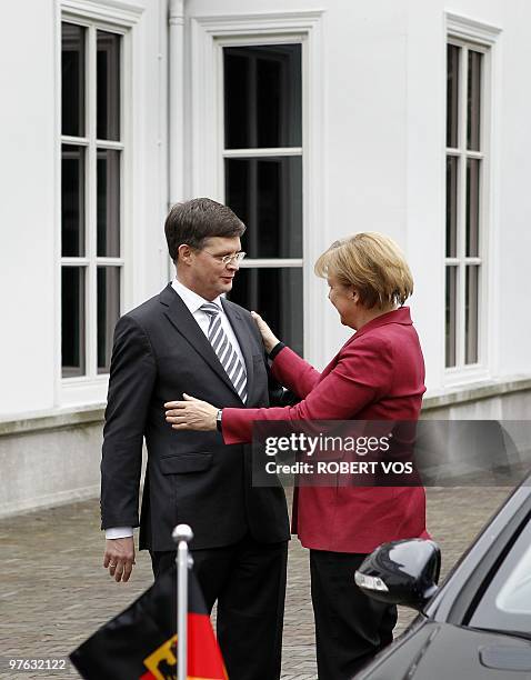 German Chancellor Angela Merkel says goodbye to Dutch prime minister Jan Peter Balkenende after their meeting in The Hague, on March 11, 2010. Merkel...