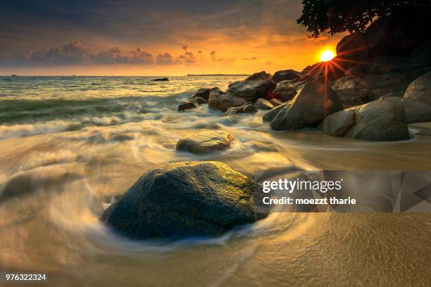 beach at sunrise, bintan island, riau islands, indonesia - riau images stock-fotos und bilder