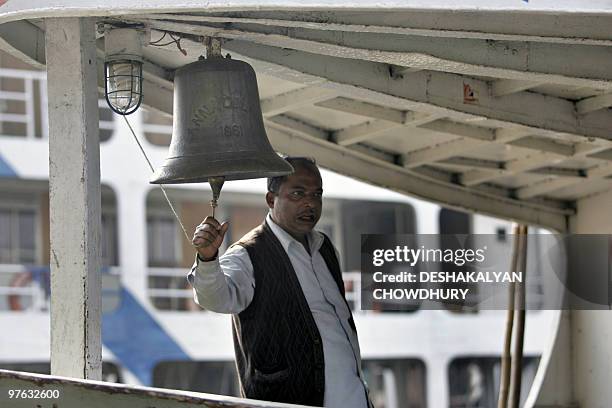 Launch deckhand rings a bell, announcing the vessel's departure from the Sadarghat Launch Terminal in Dhaka on January 9, 2009. The Sadarghat Launch...