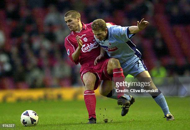 Mark Robins of Rotherham is challenged by Michael Owen of Liverpool during the AXA F.A.Cup third round tie between Liverpool and Rotheram at...