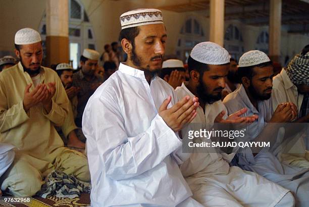 Pakistani Muslims attend Friday prayers at the Red Mosque in Islamabad on July 10 the second anniversary of a military assault on the mosque....