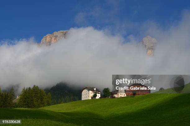 rural landscape with clouds, colfosco, bolzano, altoadige, italy - colfosco stockfoto's en -beelden