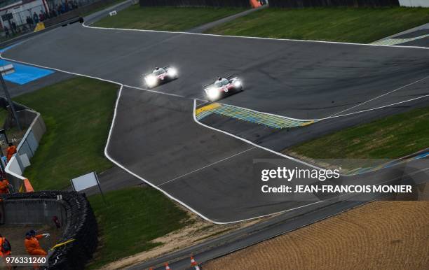 Toyota TS050 Hybrid LMP1 Spain's driver Fernando Alonso competes ahead of the Toyota TS050 Hybrid LMP1 driven by Argentine's Jose Maria Lopez during...