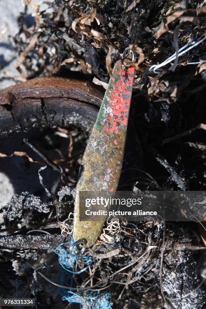 June 2018, Germany, Glowe: Garbage lying on the Baltic Sea beach on the island of Ruegen. Trash, especially from shipping, tourism and fishing, leads...