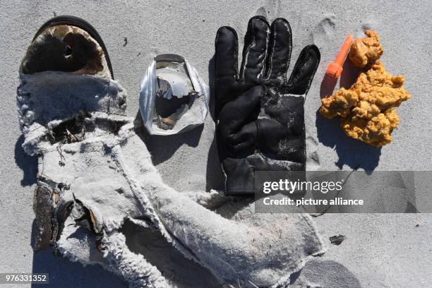 June 2018, Germany, Glowe: Garbage lying on the Baltic Sea beach on the island of Ruegen. Trash, especially from shipping, tourism and fishing, leads...